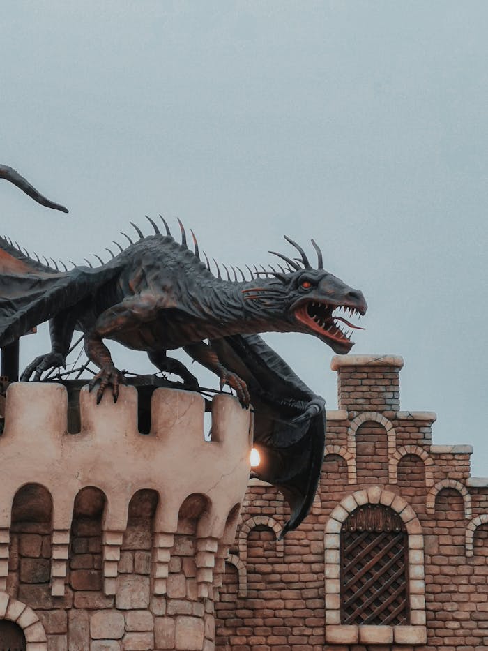 A vivid close-up of a dragon sculpture on a medieval brick castle turret.